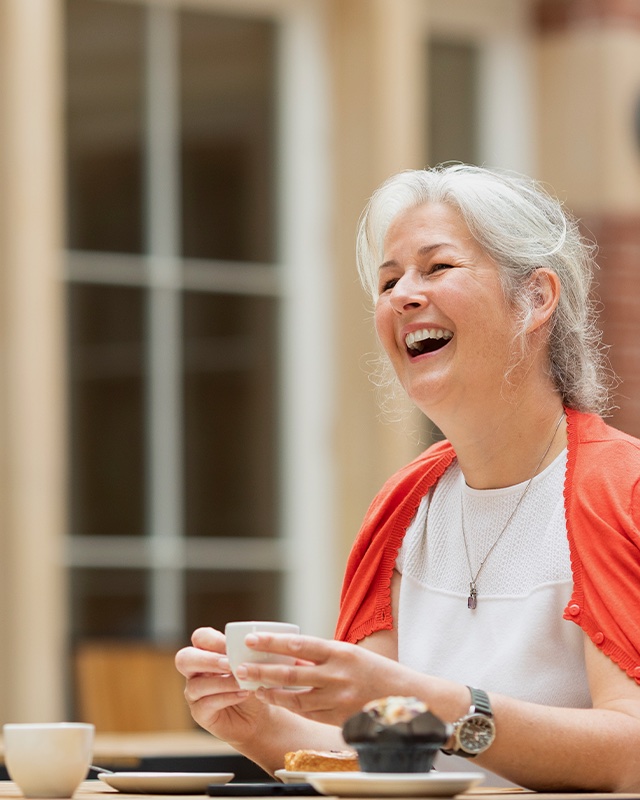 A woman enjoying a drink in the RCM cafe